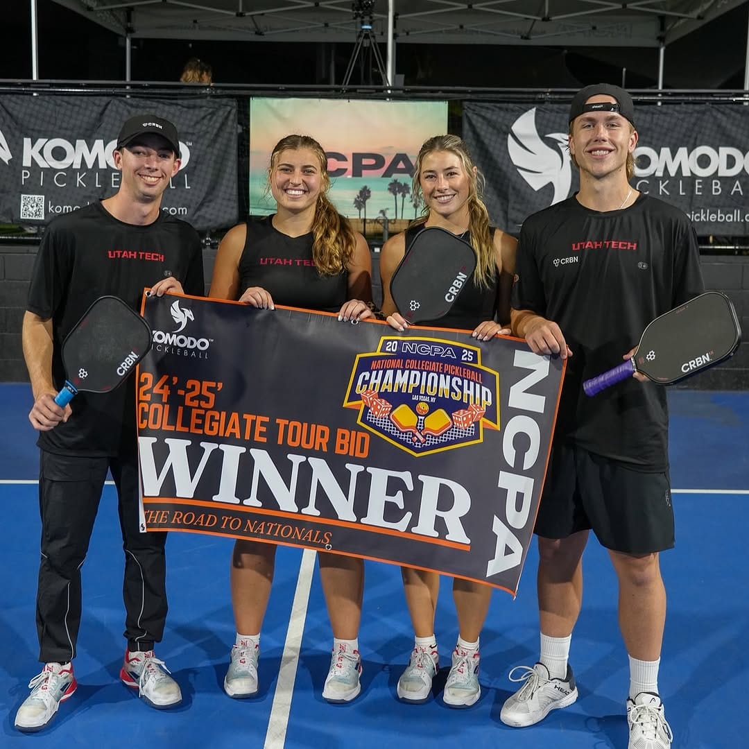 College Players Holding a Winner Banner